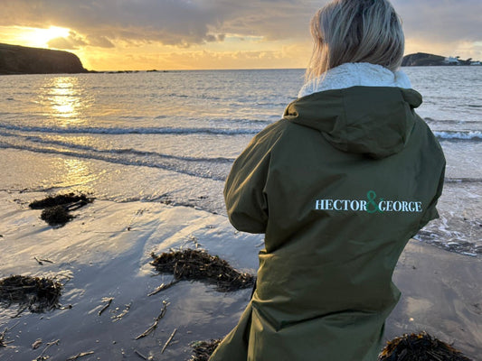 woman wearing hector and george coat on the beach
